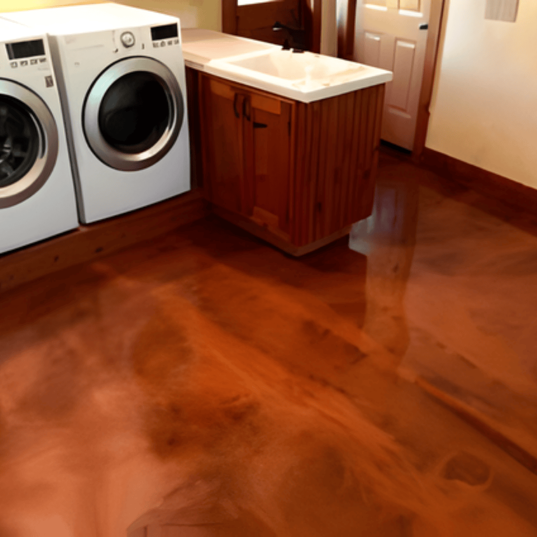 Laundry room with copper-colored epoxy floor, white washer/dryer, and wood cabinets.