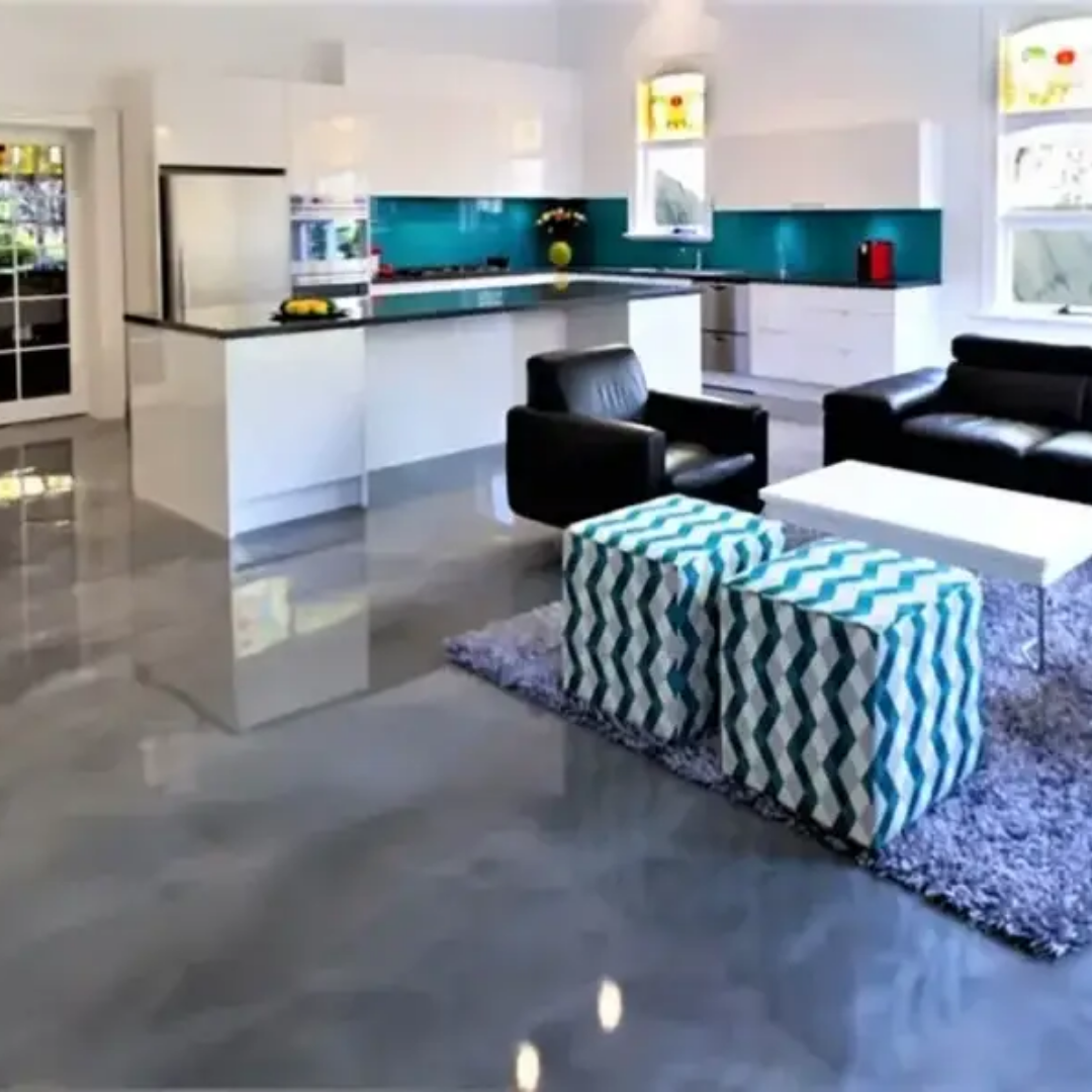 Modern open-plan kitchen and living room with shiny gray floors, white cabinets, and turquoise backsplash.