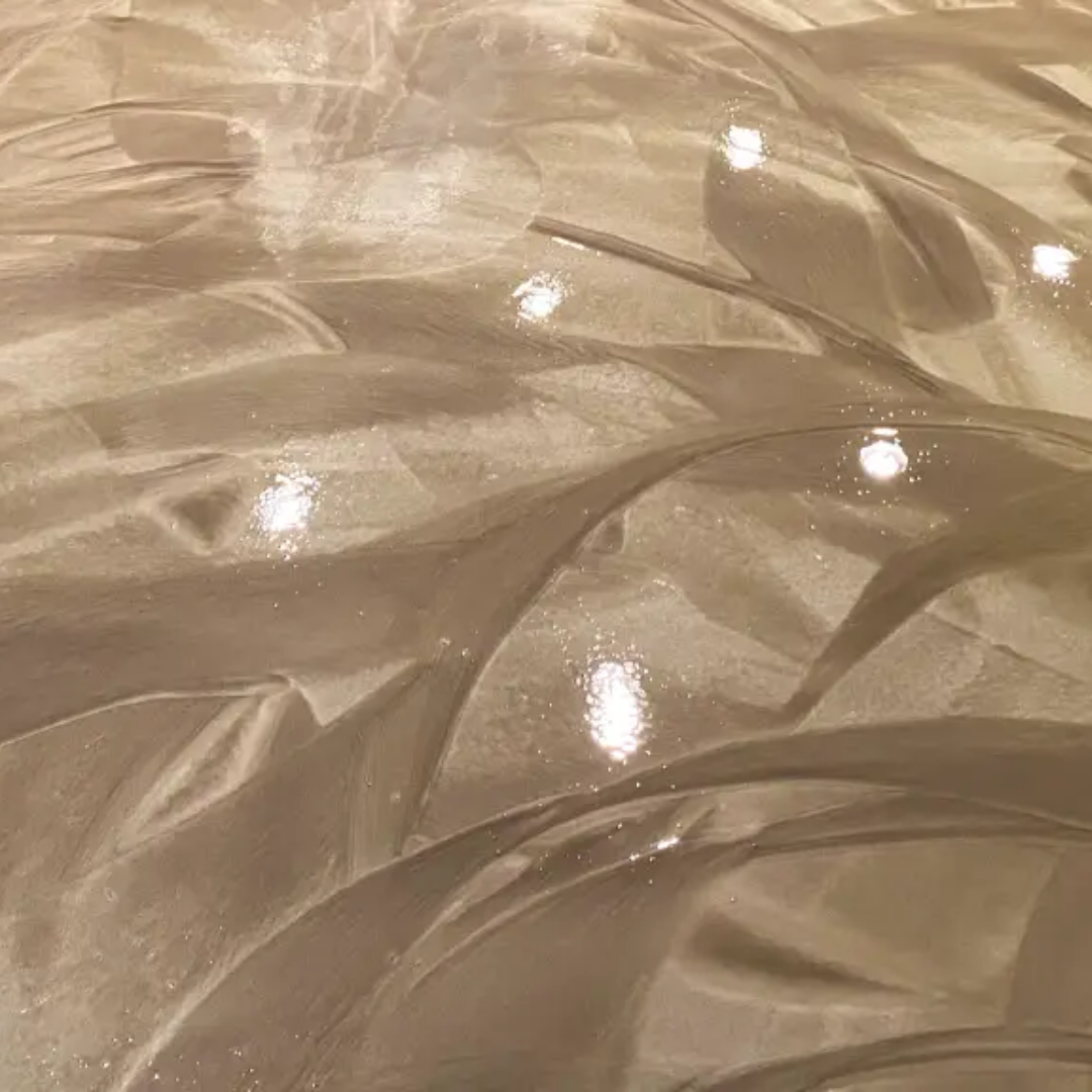 Metallic, flowing epoxy floor with swirls and light reflections.