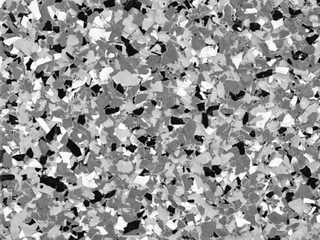 Black, white, and gray speckled flooring, resembling chips of varying sizes.